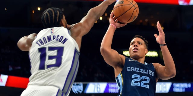 MEMPHIS, TENNESSEE - NOVEMBER 28: Desmond Bane #22 of the Memphis Grizzlies shoots against Tristan Thompson #13 of the Sacramento Kings during the second half at FedExForum on November 28, 2021 in Memphis, Tennessee.