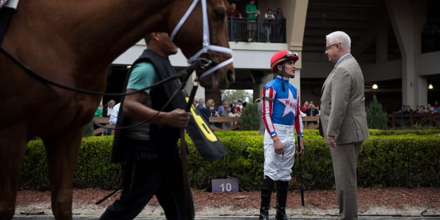 NEW ORLEANS - FEB 21: Donegal Racing president Jerry Crawford talks with jockey Miguel Mena on February 21, 2015 at the Fair Grounds Race Track in New Orleans. Crawford says that Mena sometimes rides Donegal horses. (Photo by Edmund D. Fountain for The Washington Post via Getty Images)