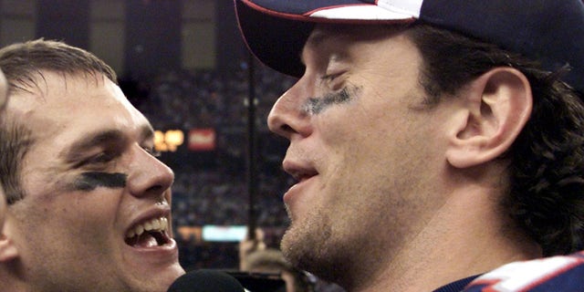 New England Patriots quarterbacks Tom Brady (L) and Drew Bledsoe (R) celebrate their team's victory over the St. Louis Rams in the 2002 Super Bowl in New Orleans. The Patriots defeated the Rams 20-17. (Jeff Haynes/AFP via Getty Images)