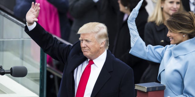 President Trump and first lady Melania Trump wave to the crowds after he was sworn in as the 45th president of the United States, on Jan. 20, 2017. (Samuel Corum/Anadolu Agency/Getty Images)