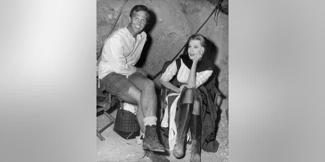 Pat Boone sits with Arlene Dahl on set of the film 'Journey To The Center Of The Earth', 1959.