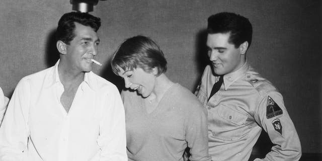 Dean Martin celebrating his birthday with Shirley MacLaine and Elvis Presley while in production for director Joseph Anthony's film, 'All in a Night's Work'. 