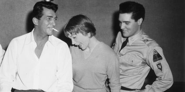 Dean Martin celebrating his birthday with Shirley MacLaine and Elvis Presley while in production for director Joseph Anthony's film, 'All in a Night's Work'. 