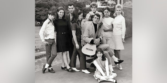 Entertainer Dean Martin (1917-1995) with his wife Jeanne (1927-2016) and children (Gail, Craig, Claudia, Deana, Gina, Ricci and Dean Paul) pose for a family portrait in 1966 in Los Angeles, California. 