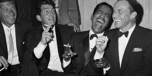 Jan Murray (L) sits alongside Rat Pack members Dean Martin, Sammy Davis Jr., and Frank Sinatra as the group unwinds backstage at Carnegie Hall after entertaining at a benefit performance in honor of Dr. Martin Luther King Jr.