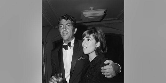 American actor and singer Dean Martin (1917 - 1995) with his arm around his daughter Deana at a Hollywood event, December 1965.