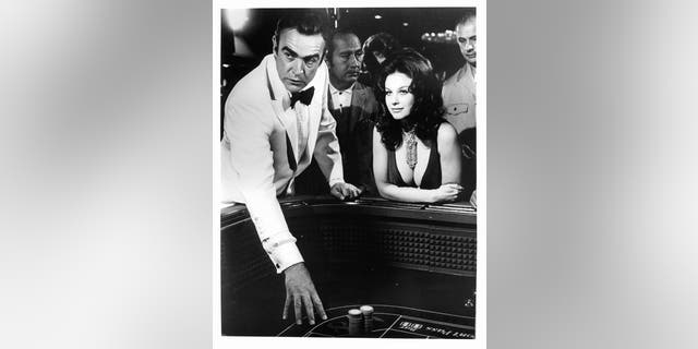 Sean Connery and Lana Wood at the gambling table in a scene from the film ‘Diamonds Are Forever’.