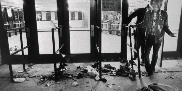 Debris litters the ground in front of the doors where 11 people died as they attempted to enter the Riverfront Coliseum for a concert by The Who. Numerous injuries were also reported in what one survivor called a "nightmare."