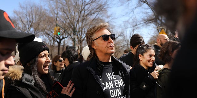 Sir Paul McCartney marched against gun violence in Manhattan during the March for Our Lives demonstration on March 24, 2018 in New York City.  John Lennon entered his luxurious Manhattan apartment when he was shot nearby with a .38-caliber revolver.