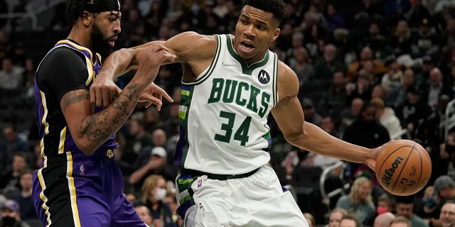 The Milwaukee Bucks' Giannis Antetokounmpo tries to get past the Los Angeles Lakers' Anthony Davis during the second half of a game Wednesday, Nov. 17, 2021, in Milwaukee.