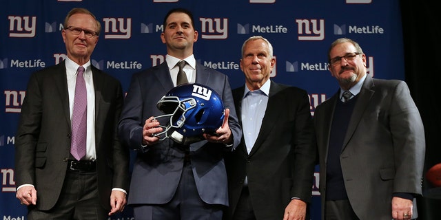 New York Giants new head coach Joe Judge, center, poses for photographs with team CEO John Mara, left, chairman and executive vice president Steve Tisch, and general manager Dave Gettleman, right, after a news conference at MetLife Stadium on Jan. 9, 2020, in East Rutherford, New Jersey. 