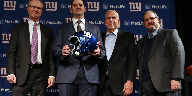 New York Giants new head coach Joe Judge, center, poses for photographs with team CEO John Mara, left, chairman and executive vice president Steve Tisch, and general manager Dave Gettleman, right, after a news conference at MetLife Stadium on Jan. 9, 2020, in East Rutherford, New Jersey.