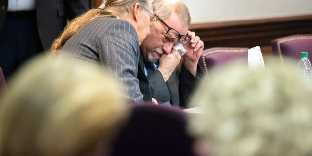 Greg McMichael wipes his eyes during a recess in the testimony of his son Travis McMichael during their trial and trial of their neighbor William "Roddie" Bryan at the Glynn County Courthouse, Wednesday, Nov. 17, 2021, in Brunswick, Georgia. (AP Photo/Stephen B. Morton, Pool)