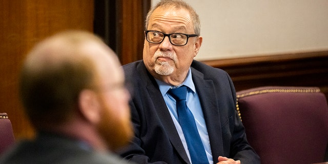 Greg McMichael, center, sits next to his attorney during the trial of Greg McMichael and his son, Travis McMichael, and a neighbor, William "Roddie" Bryan in the Glynn County Courthouse, Monday, Nov. 15, 2021, in Brunswick, Georgia. 