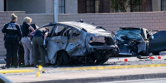 Las Vegas Metro Police investigators work at the scene of a fatal crash Tuesday, Nov. 2, 2021, in Las Vegas. Police in Las Vegas say Las Vegas Raiders wide receiver Henry Ruggs III was involved in the fiery vehicle crash early Tuesday that left a woman dead and Ruggs and his female passenger injured.