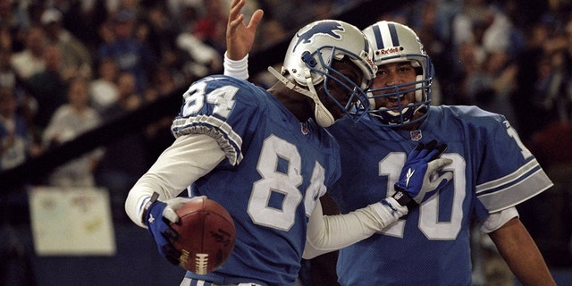 November 26, 1998: QB Charlie Batch No.  30 wide receiver Herman Moore No.  84 of the Detroit Lions celebrate during the game against the Pittsburgh Steelers at the Pontiac Silverdome in Pontiac, Michigan.  The Lions defeated the Steelers 19-16.