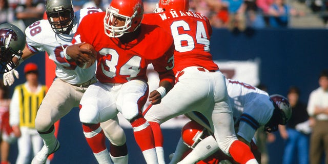 Running back Herschel Walker (34) of the New Jersey Generals carries the ball against the Birmingham Stallions in 1983 during a USFL football game at The Meadowlands in East Rutherford, N.J. Walker played for the Generals from 1983-1985.