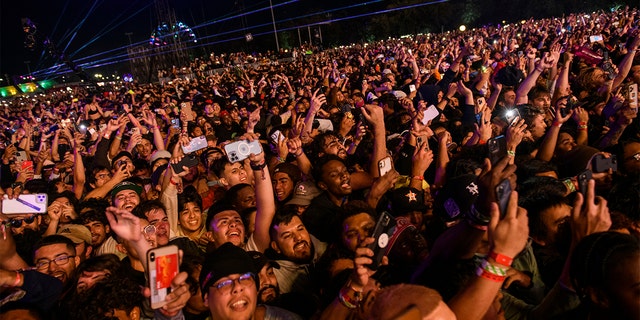 The crowd watches as Travis Scott performs at Astroworld Festival at NRG park on Friday, Nov.  5, 2021 in Houston, where eight people died and numerous others were injured in what officials described as a surge of the crowd at the music festival.