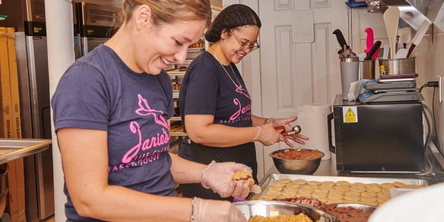 Janie Deegan, owner of Janie's Life-Changing Baked Goods in Manhattan, New York, making cookies with staff. 