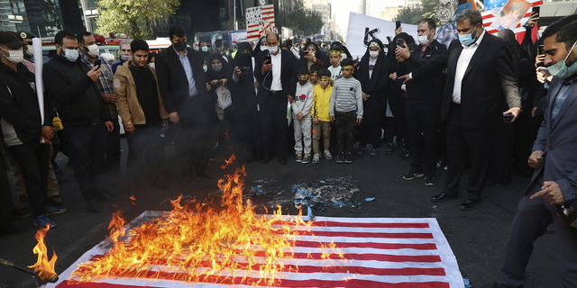 Demonstrators set fire to a mock U.S. flag during a rally in front of the former U.S. Embassy commemorating the anniversary of its 1979 seizure in Tehran, Iran, on Thursday.