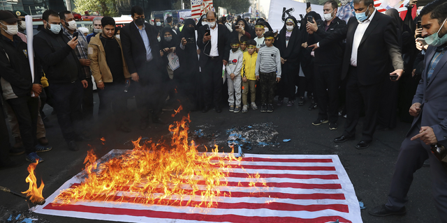 Demonstrators set fire to a mock U.S. flag during a rally in front of the former U.S. Embassy commemorating the anniversary of its 1979 seizure in Tehran, Iran, on Thursday.