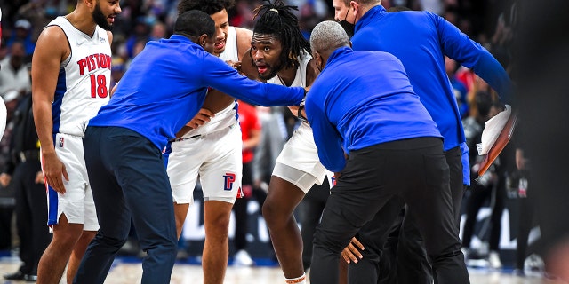 DETROIT, MICHIGAN - NOVEMBER 21: Isaiah Stewart #28 of the Detroit Pistons is restrained after receiving a blow to the face by LeBron James #6 of the Los Angeles Lakers during the third quarter of the game at Little Caesars Arena on November 21, 2021 in Detroit, Michigan.