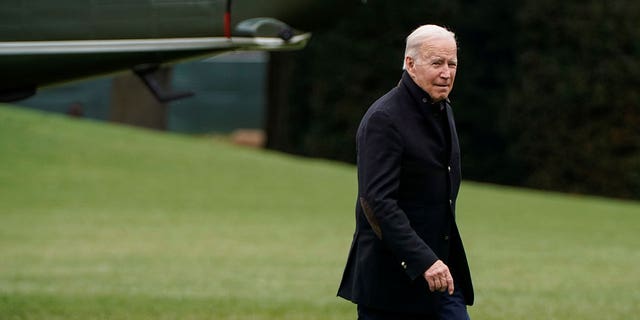 President Joe Biden walks from Marine One as he arrives at the White House.