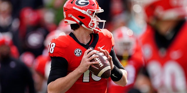 Georgia quarterback JT Daniels (18) looks for an open receiver in the second half of an NCAA college football game against Missouri on Saturday, Nov. 6, 2021, in Athens, Ga..
