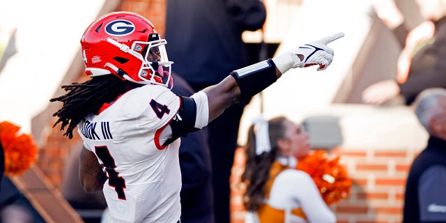 Georgia running back James Cook (4) points to fans as he scores a touchdown during the first half of an NCAA college football game against Tennessee, Saturday, Nov. 13, 2021, in Knoxville, Tenn.