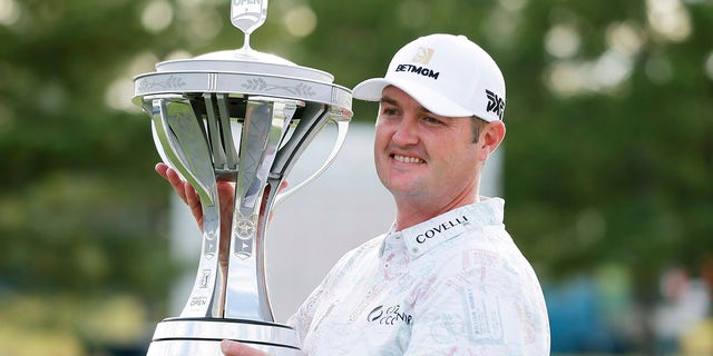 Tournament winner Jason Kokrak holds the trophy during presentation ceremonies following the final round of the Houston Open golf tournament on Sunday, November 14, 2021 in Houston.