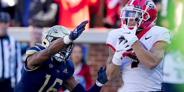 Georgia wide receiver Jermaine Burton (7) makes a catch for a touchdown as Georgia Tech defensive back Myles Sims (16) defends in the first half of an NCAA college football game Saturday, Nov. 27, 2021, ad Atlanta.