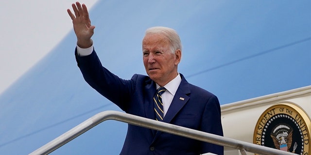 President Biden waves as he boards Air Force One after attending the G20 summit in Rome, Monday, Nov. 1, 2021.