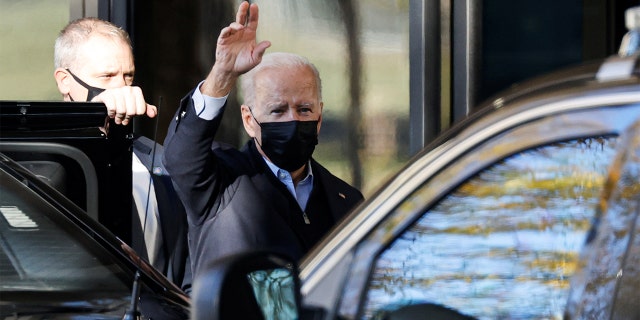 President Biden waves to reporters as he arrives for his annual physical at Walter Reed National Military Medical Center in Bethesda, Maryland, Nov. 19, 2021.