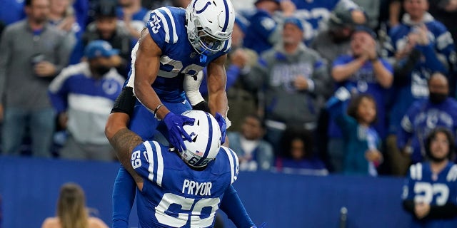 Indianapolis Colts' Jonathan Taylor (28) celebrates running for a touchdown with Matt Pryor (69) during the second half of an NFL football game against the New York Jets, Thursday, Nov. 4, 2021, in Indianapolis.