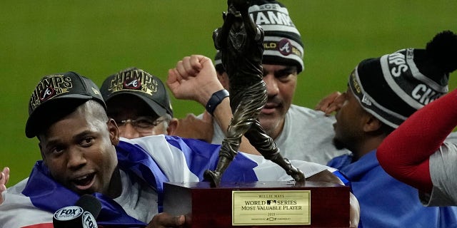 Atlanta Braves designated hitter Jorge Soler holds up the MVP trophy after winning baseball's World Series in Game 6 against the Houston Astros Tuesday, Nov. 2, 2021, in Houston. The Braves won 7-0.