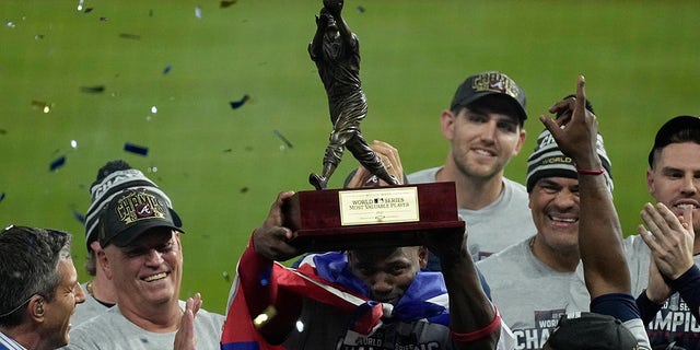 Atlanta Braves designated hitter Jorge Soler holds up the MVP trophy after winning baseball's World Series in Game 6 against the Houston Astros Tuesday, Nov. 2, 2021, in Houston. The Braves won 7-0.
