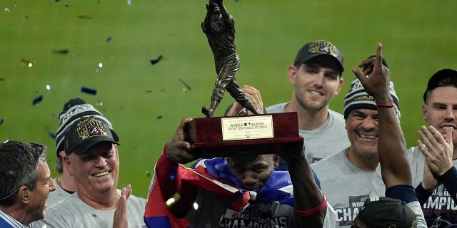Atlanta Braves designated hitter Jorge Soler holds up the MVP trophy after winning baseball's World Series in Game 6 against the Houston Astros Tuesday, Nov. 2, 2021, in Houston. The Braves won 7-0.