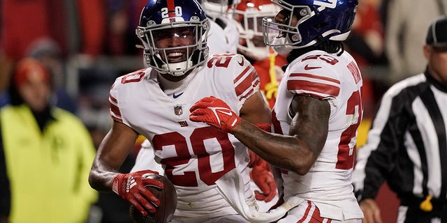 New York Giants safety Julian Love (20) is congratulated by cornerback Logan Ryan, right, after intercepting a pass during the first half of an NFL football game against the Kansas City Chiefs Monday, Nov. 1, 2021, in Kansas City, Mo.