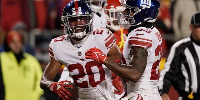 New York Giants safety Julian Love (20) is congratulated by cornerback Logan Ryan, right, after intercepting a pass during the first half of an NFL football game against the Kansas City Chiefs Monday, Nov. 1, 2021, in Kansas City, Mo.