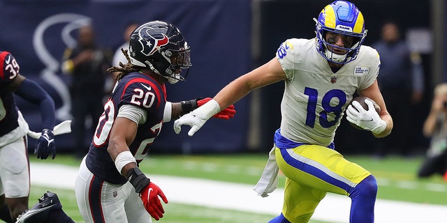 Ben Skowronek (18) of the Los Angeles Rams runs with the ball after a reception as Justin Reid (20) of the Houston Texans pursues at NRG Stadium Oct. 31, 2021 in Houston.