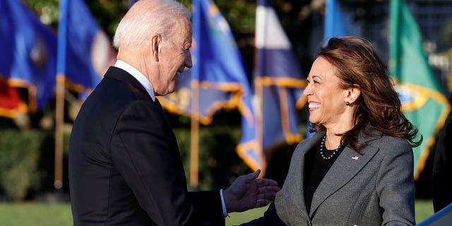 President Biden and Vice President Kamala Harris greet each other on the South Lawn outside the White House in Washington, Nov. 15, 2021.