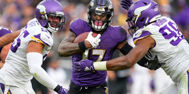 Minnesota Vikings outside linebacker Anthony Barr (55) and defensive end D.J. Wonnum (98) combine against Baltimore Ravens running back Le'Veon Bell (17) during the second half of an NFL football game, Sunday, Nov. 7, 2021, in Baltimore.