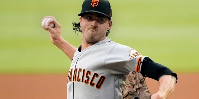 FILE -San Francisco Giants stating pitcher Kevin Gausman works against the Atlanta Braves during the first inning of a baseball game Friday, Aug. 27, 2021, in Atlanta. The Toronto Blue Jays have reached an agreement with right-hander Kevin Gausman on a five-year, $110 million contract, pending a physical, a person familiar with the deal told The Associated Press late Sunday, Nov. 28, 2021.
