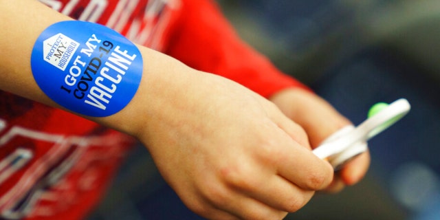 James Marshall, 5, wears a sticker after receiving the Pfizer COVID-19 vaccine for children in Cranston, Rhode Island, on Nov. 4, 2021.