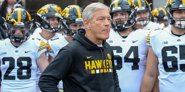 Head coach Kirk Ferentz of the Iowa Hawkeyes waits with the team before the game against the Nebraska Cornhuskers at Memorial Stadium on Nov. 26, 2021, in Lincoln, Nebraska.