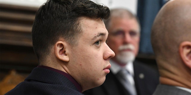 Kyle Rittenhouse watches as Dr. John Black testifies during his trial at the Kenosha County Courthouse in Kenosha, Wisconsin, on Thursday, Nov. 11, 2021. 