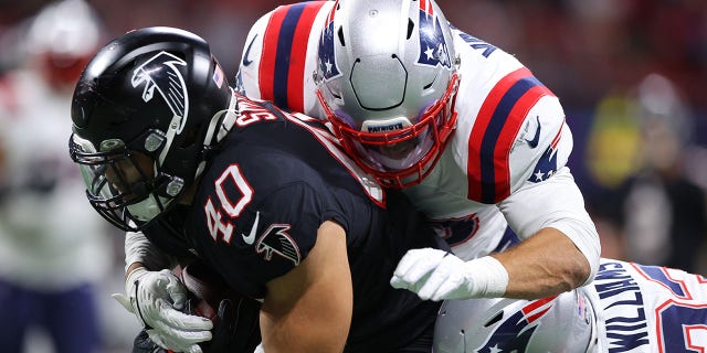 Keith Smith (40) of the Atlanta Falcons is tackled by Kyle Van Noy (53) of the New England Patriots in the third quarter at Mercedes-Benz Stadium on Nov. 18, 2021, in Atlanta, Georgia.