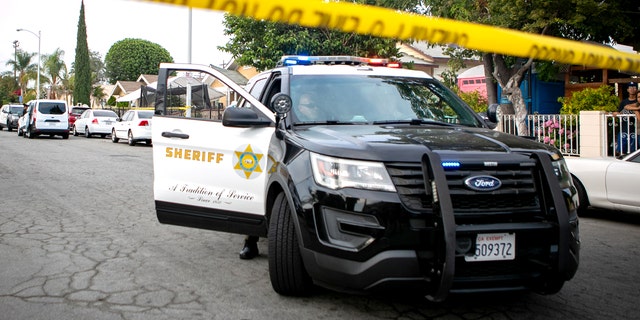 EAST LOS ANGELES, CA - JUNE 28: Police work the crime scene where three children were found dead at a home on South Ferris Ave in East Los Angeles on Monday, June 28, 2021 in East Los Angeles, CA.