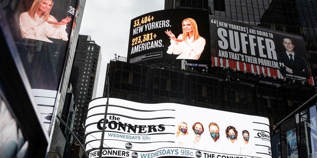 Images of Ivanka Trump and Jared Kushner alongside messages about coronavirus disease (COVID-19) infections and deaths on billboards sponsored by The Lincoln Project above Times Square in New York City, Oct. 24, 2020. Trump and Kushner's lawyer Marc Kasowitz has demanded that the billboards be removed, threatening a lawsuit.