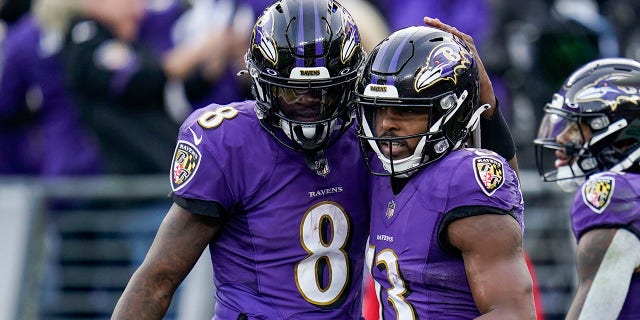 Ravens quarterback Lamar Jackson (8) and wide receiver Devin Duvernay celebrate a touchdown against the Minnesota Vikings, on Nov. 7, 2021, in Baltimore.